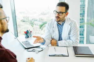 Portrait of a young doctor talking to his patient in his office. healthcare and medicine concept