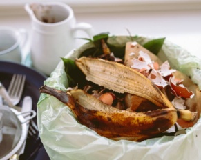 Sorting food waste at home. Distribution of food leftovers in bin with bio-garbage. Leftover food in trash can in kitchen